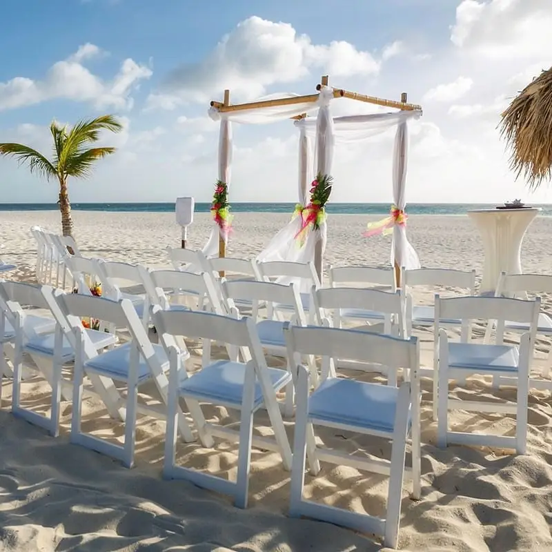 A beach wedding set up of an alter and white chairs at Manchebo Beach Resort in Aruba
