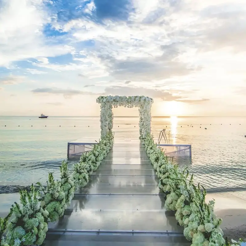 A flower covered aisle and alter stretch into the water at Azul Beach Resort in Negril Jamaica
