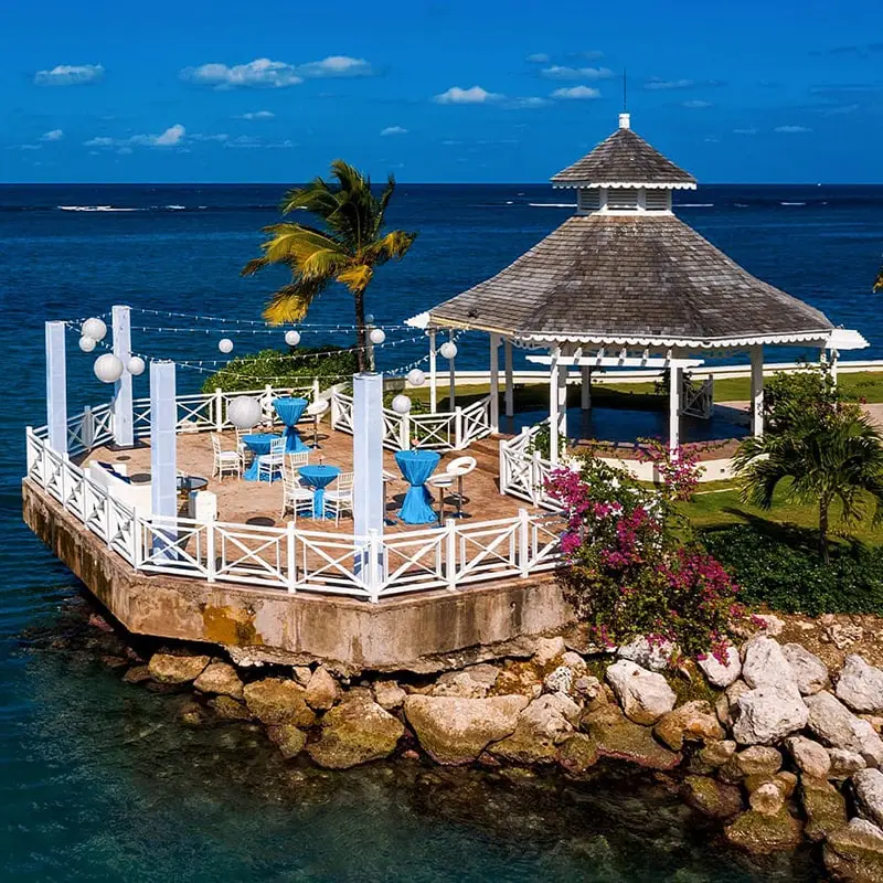 Grey-roofed gazebo with tables decorated for a destination wedding at Moon Palace Jamaica