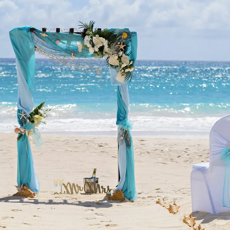 Turquoise draped alter on the beach for a destination beach wedding in Barbados