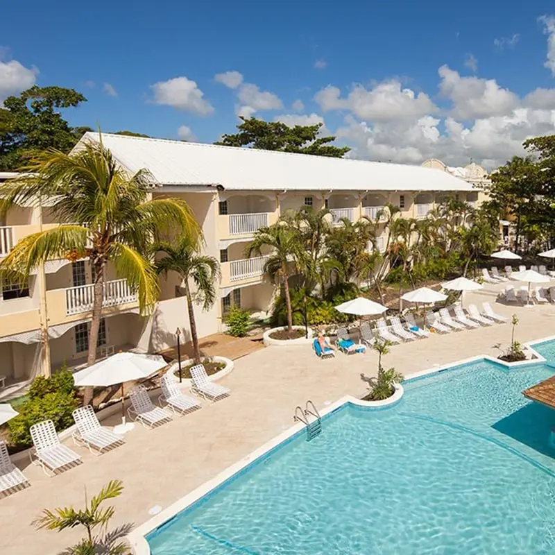 Sugar bay resort with pool, palm trees, and blue sky