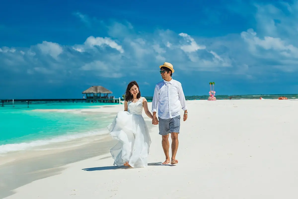 Happy couple on the beach after their destination wedding