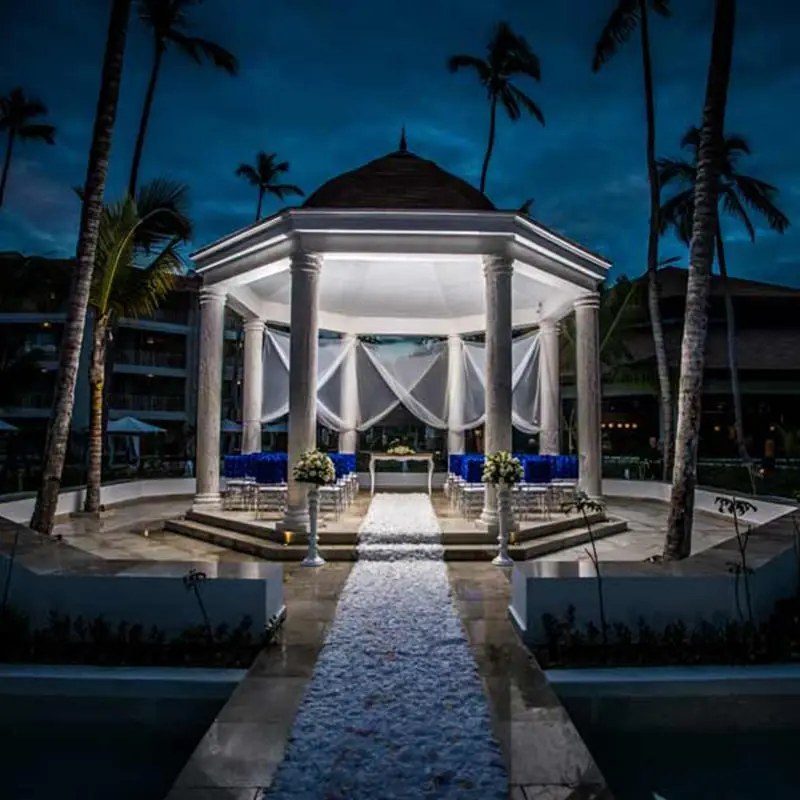 A white gazebo is lit up at night for an evening destination wedding at the Majestic Mirage
